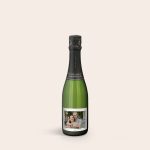 Green bottle of champagne with a personalized label featuring a photo of a couple printed on the front