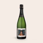 Green champagne bottle with a personalized label, printed with a photo of a woman, the number 35, and "Cheers to" text.