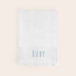 Personalised white bath towel embroidered with the name RUBY in blue thread, perfect to create something special.