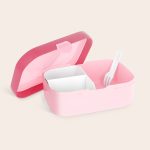 Open pink personalized Mepal lunchbox with three compartments and a white fork. Their name makes lunchtime special.