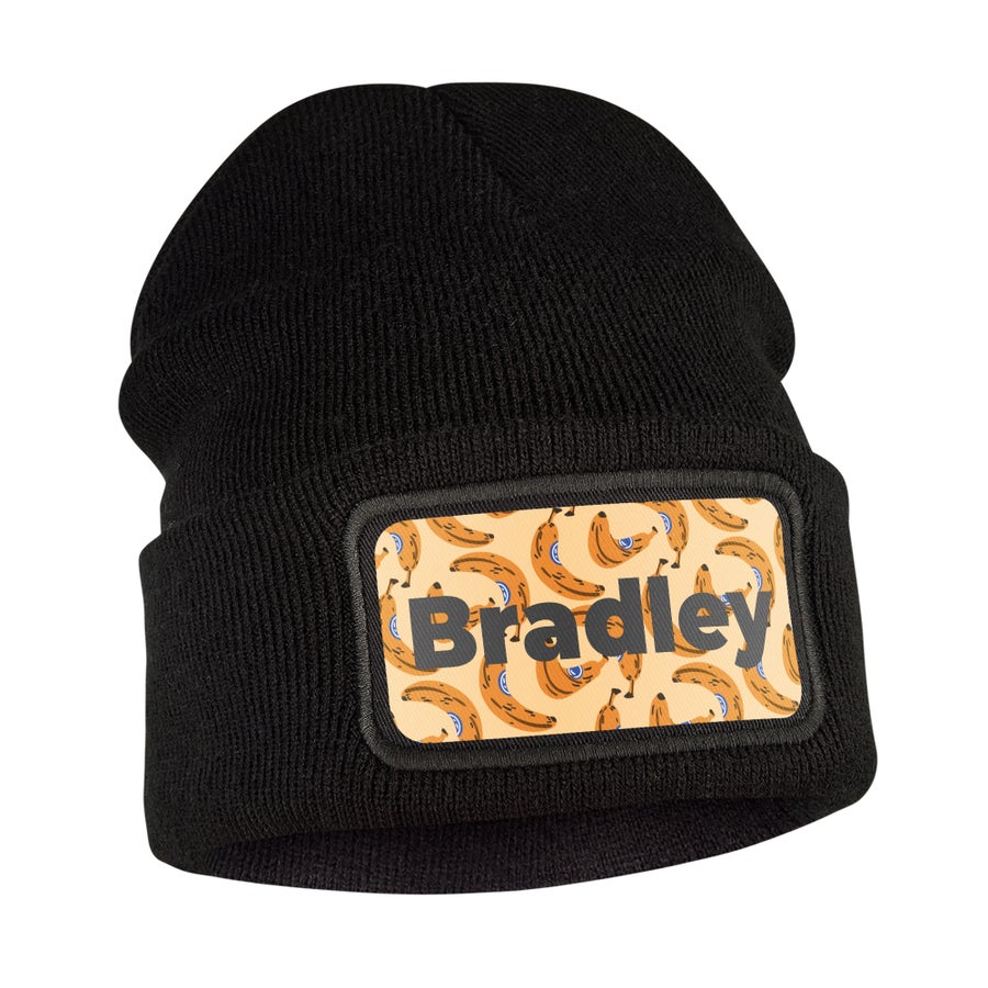 Black custom beanie with a printed banana pattern and the name Bradley to keep ears warm.