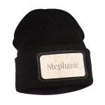 Black custom beanie with a cream patch printed with the name Stephanie and a floral design