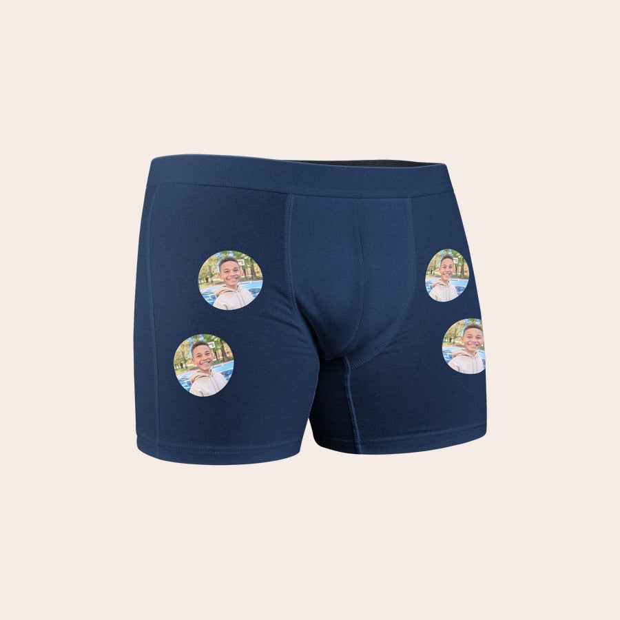 Dark blue personalized boys boxer shorts printed with four circular photos of a smiling boy