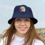Woman wearing a dark blue personalised bucket hat printed with a circular photo of three friends laughing