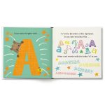 Open personalized children's book with name, showing "Your name begins with..." and the letter A. Celebrate being 2.