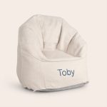 Cream children's chair with the name Toby embroidered in blue, a cool trendy chair