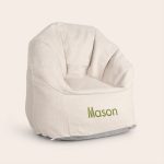 Personalized children's chair with "Mason" embroidered in green. A cool, trendy chair in a light color.