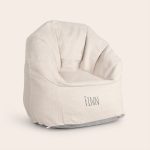 Cream children's bean bag chair embroidered with the name Finn on the front. A cool trendy chair.