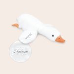 White soft personalised cuddly toy goose with orange feet and beak, embroidered with the name Madison on its wing.