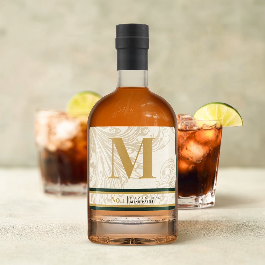 Bottle of dark rum with a personalized label, printed with a large gold M and the name Mike Prins.