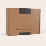 Brown cardboard box for an Espresso Martini gift set with "This surprise is for you" printed on the lid
