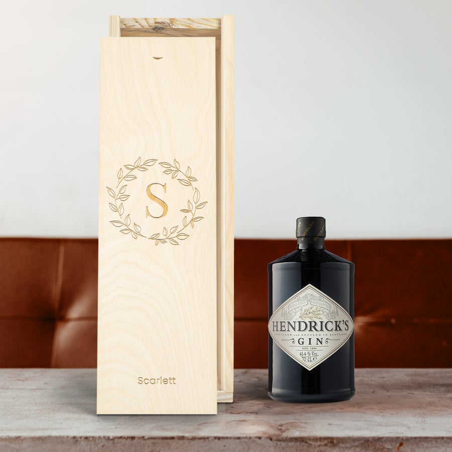 Hendricks gin bottle next to an engraved wooden case with a personalized initial and name