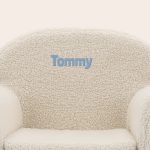 Off-white personalised kids teddy chair with the name Tommy embroidered in blue.