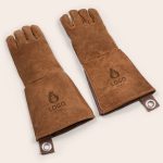 A pair of brown engraved leather BBQ gloves with a custom logo graphic on each glove.