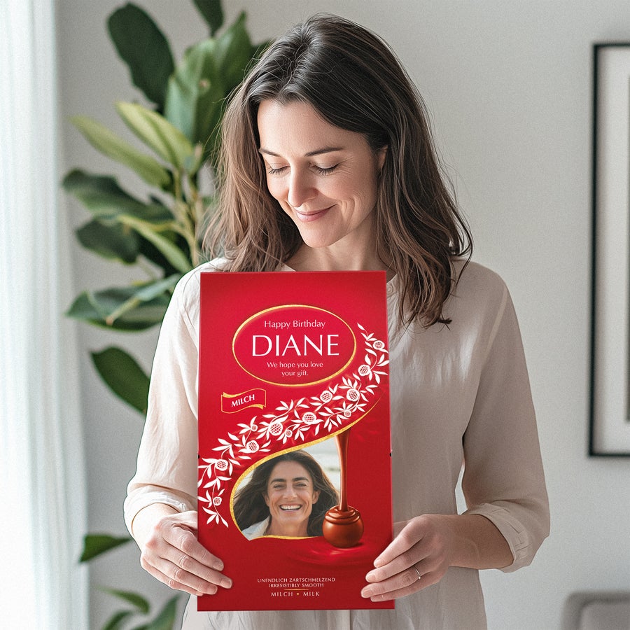 A woman holding a personalized Lindor chocolate gift box with a photo, name Diane and birthday text.