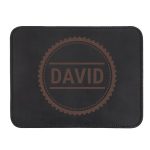 Black leather mousepad with DAVID engraved in a brown circular design