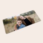 Personalized mouse mat printed with a photo of two young boys hugging in a field.