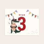 Personalized birthday card with a cartoon alligator wearing a party hat, holding a cake, printed with the name Ryan and the number 3.