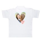 White polo shirt for kids, printed with a heart-shaped photo of two girls and the word "CUTE!".