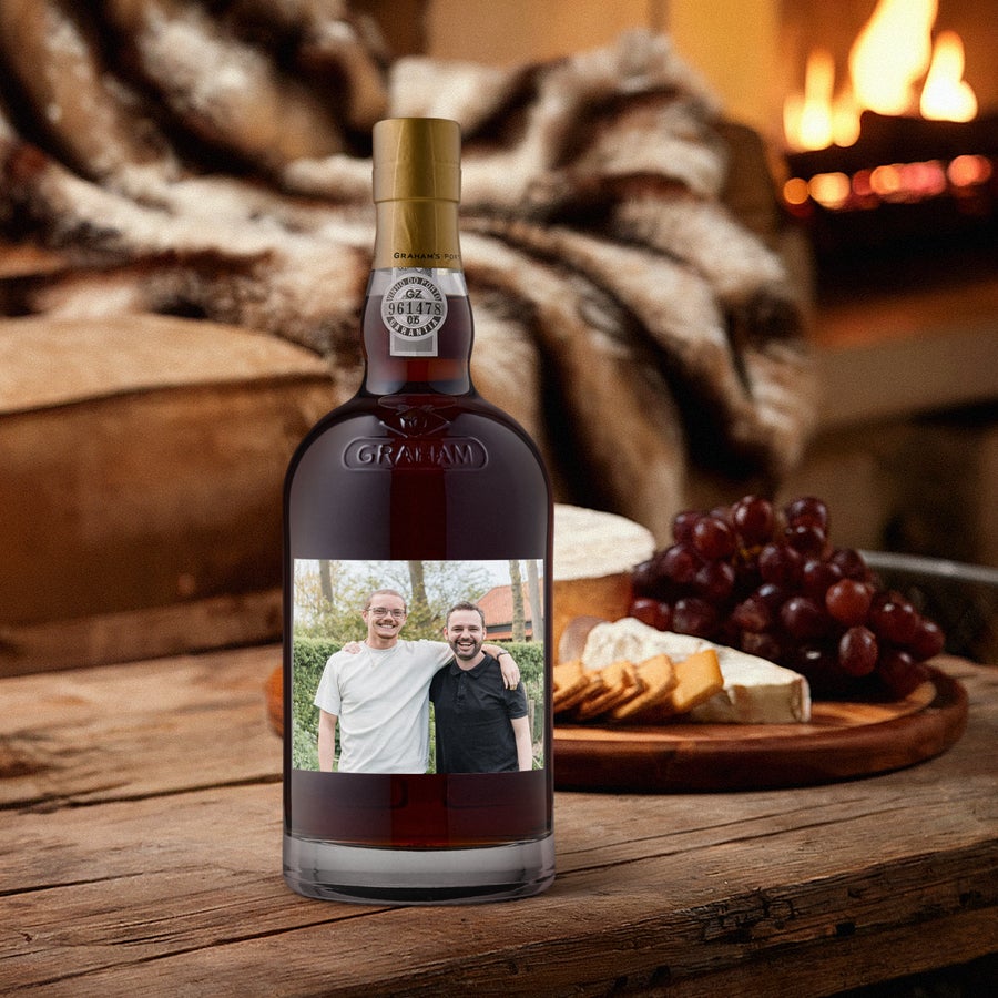 A personalized Graham's 20 years port bottle with a custom photo label featuring two men.