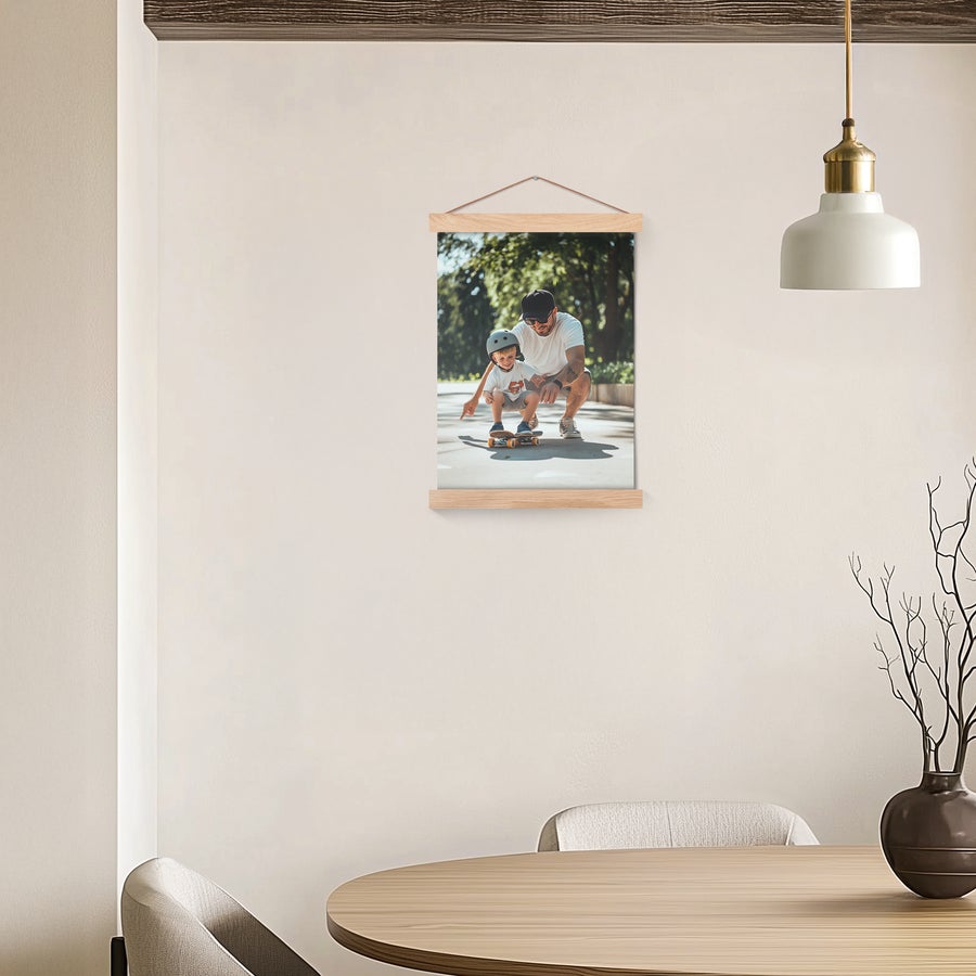 Magnetic poster hanger with a printed photo of a man and child skateboarding on a wall