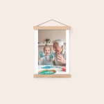 Customized photo poster with a magnetic poster hanger featuring a toddler and man finger painting