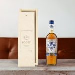 Old Captain brown rum in an engraved wooden case with the custom name Scott
