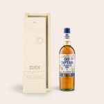 Old Captain brown rum bottle next to a personalized wooden case engraved with Eden and Happy Birthday