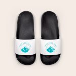 A pair of black and white personalised sliders for summer, printed with a mountain logo and text Your Logo Here