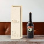 Baileys Original liqueur bottle next to an open engraved wooden case with Happy Birthday Mike text