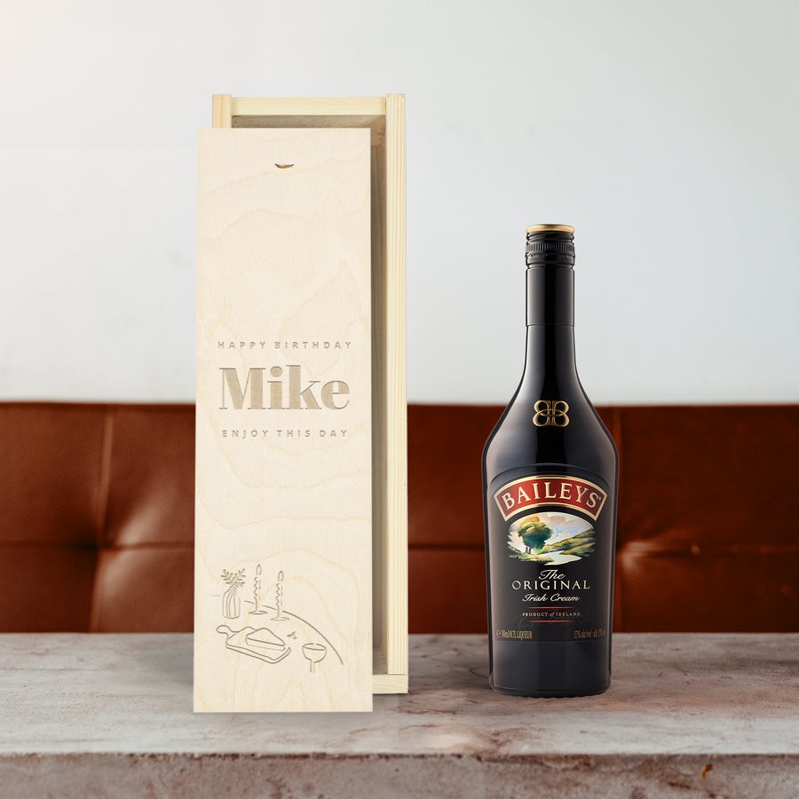 Baileys Original liqueur bottle next to an open engraved wooden case with Happy Birthday Mike text