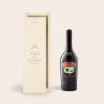 A bottle of Baileys Original liqueur next to an engraved wooden case with the text Noah Happy Birthday Sunshine