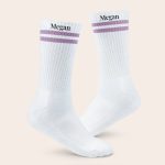 White sports socks with lilac stripes, personalized with the name Megan printed in black text at the top.