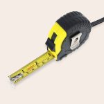 A personalized tape measure with a yellow and black case extended to show the measurements on the tape Measure Twice.