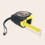 Black and yellow tape measure with a photo of a couple printed on a round top plate for a personalized measuring tape