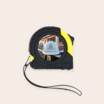 Black and yellow tape measure with a white hard hat and