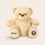 Cute personalized teddy bear with a printed photo and name Mason on its feet pockets
