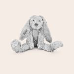 A grey Tiny Rabbit Richie cuddly toy with the name Maya embroidered on its right ear, providing endless cuddles.