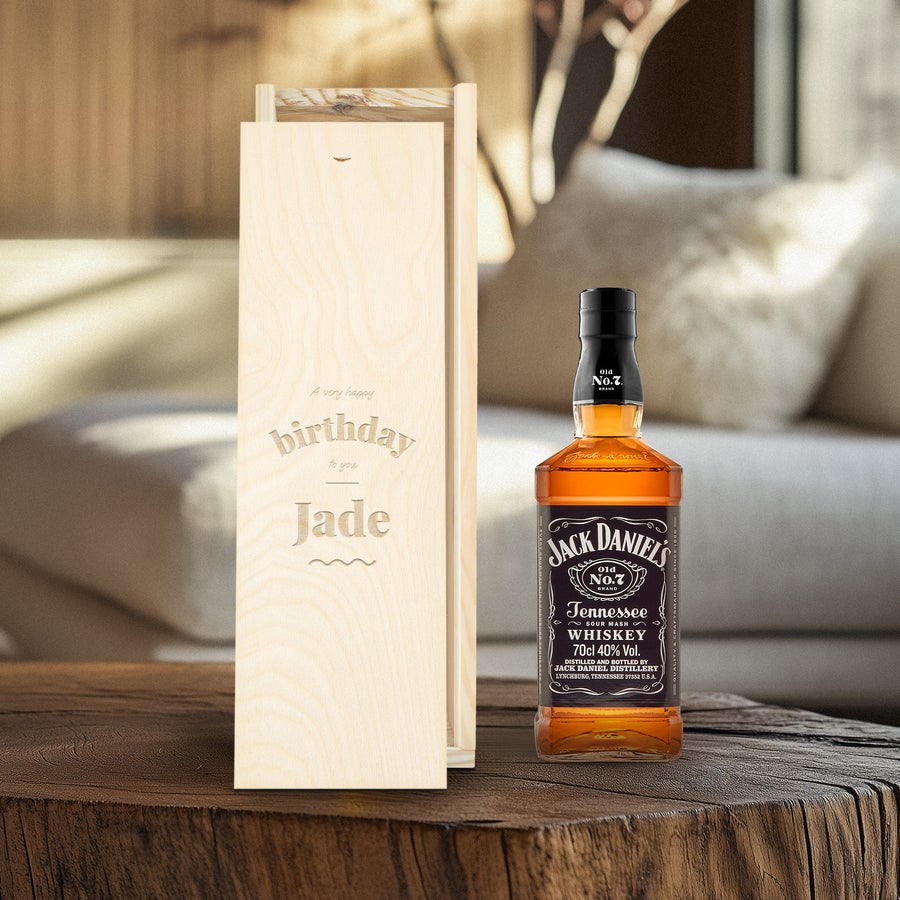 Bottle of Jack Daniels whisky with an engraved wooden case featuring a custom birthday message and name