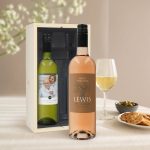 Two personalized Belvy white and rosé wine bottles with custom printed labels in a wooden gift box