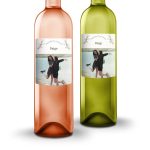 Two bottles of Oude Kaap wine, one rosé and one white, with personalized photo labels featuring two women by the water and the text Paige and Congratulations