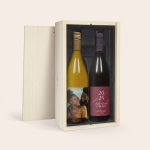 Two Salentein wine bottles in a wooden box, one with a personalized photo label and the other with a custom text label.