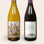 Two bottles of wine, one with a custom photo label of a family, and the other with a Chateau Campbell label.
