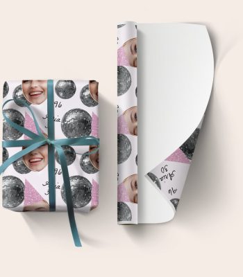 Custom photo printed personalised wrapping paper with a disco ball design and custom text 'Aria 30', tied with a blue ribbon.