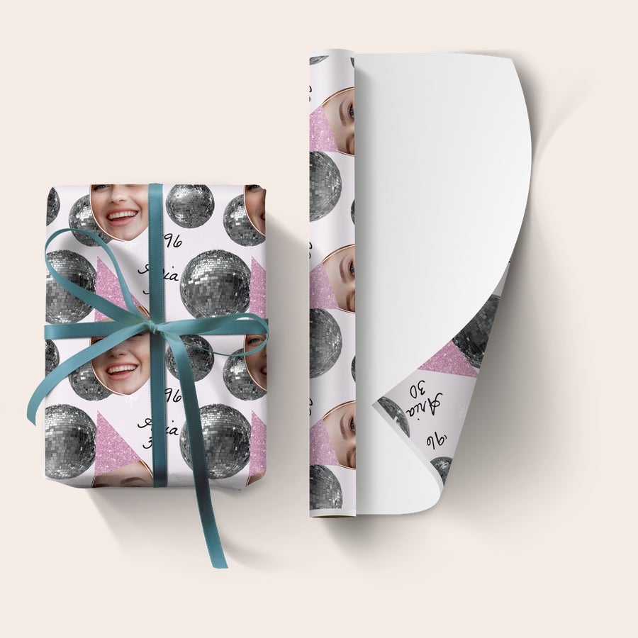 personalised-wrapping-paper.jpg Custom photo printed personalised wrapping paper with a disco ball design and custom text 'Aria 30', tied with a blue ribbon.