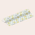 Personalised wrapping paper with a blue and cream checkered pattern, printed with smiling yellow faces and the custom name Amir.