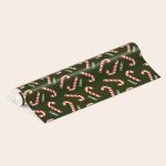 Personalised wrapping paper with candy cane design and "HARRY" printed for a festive touch.