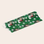 A roll of personalised wrapping paper in green, printed with soccer balls, lightning bolts, and a repeated photo of a boy in a soccer jersey and gloves, holding a ball.