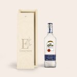 Jose Cuervo tequila bottle next to an engraved wooden gift box with the name Emerson and a custom initial