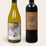 Two Maison de la Surprise wine bottles with personalized labels. The white wine has a photo printed label, and the red wine has a label with a custom name.